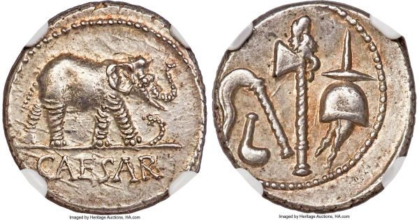 Lot 30096 > Julius Caesar, as Dictator (49-44 BC). AR denarius (18mm, 3.85 gm, 6h). NGC Choice AU 4/5 - 5/5. Military mint traveling with Caesar in northern Italy, ca. 49-48 BC. CAESAR, elephant advancing right, trampling horned serpent / Pontifical implements: simpulum, aspergillum, securis (axe surmounted by dog or wolf's head), and apex. Crawford 443/1. Sydenham 1006. Julia 9.