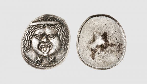 Etruria. Populonia. 211-206 BC. AR 20 Asses (9.08g). Basel 11 = Tradart 2.2 = Vecchi 51.59 (this coin). Lightly toned. Perfectly centered and struck. Superb extremely fine. From a private collection; former Athos Moretti (1907-1993) collection, Numismatica Ars Classica 1998 (13) lot 11

In ancient Greece, Gorgoneion was a special apotropaic amulet showing the Gorgon head. Often worn by Athena and Zeus as a protective pendant, it established their descent from earlier deities considered to remain powerful. It was also equally assumed by many rulers of the Hellenistic age as a royal aegis to imply divine birth or protection, as shown for instance on the Alexander mosaic and Gonzaga cameo