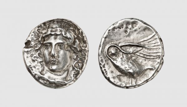 Ionia. Clazomenae. 380-360 BC. AR Tetradrachm (14.36g, 1h). Prospero 509; Ward 664 (this coin). Very rare. Old cabinet tone. With a fine portrait of Apollo in high relief and of a dazzling beauty. Usual areas of corrosion. Good very fine. From a private collection; former Metropolitan Museum of Art collection, Sotheby's 1973 (4 April) lot 556; former John Pierpont Morgan (1837-1913), John Ward (1832-1912) and William Boyde (1814-1893) collections
 
 This tetradrachm is unquestionably one of the great masterpieces of Greek numismatic art, and surely one of the loveliest. Facing heads were very difficult to engrave and only the very best, or most confident, masters attempted to do them. First used successfully on Sicilian coinage in late 5th century, there was a great vogue for such heads in the 4th century, the best known being those from Rhodes, Amphipolis and Clazomenae