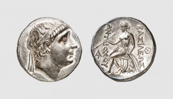 Syria. Antiochus Soter. Seleuceia ad Tigrim. 270-267 BC. AR Tetradrachm (17.14g, 3h). SC 379.3c; Tradart 3.83 (this coin). Very rare. Lightly toned. Perfectly centered and struck in high relief. One of the finest known. Superb extremely fine. From a private collection; Tradart 1994 (4) lot 104
 
 The obverse features the diademed Antiochus in his old age. His portrait was introduced to the coinage around 278 BC, along with a reverse design which was to become the standard Seleucid type of of the middle Hellenistic period. The figure of Apollo seated on his omphalos - a sacred conical stone - reflects the role played by Antiochus in shaping the cult of Apollo in Syria